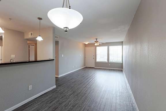 A spacious room with a grey floor and white walls.