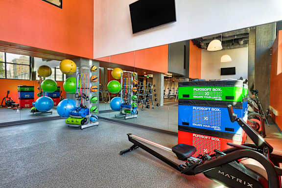 A gym with a variety of equipment including a rowing machine.at Eleven Fifty Clay Street, California