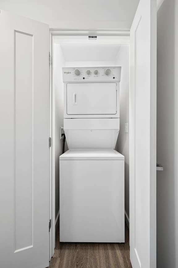 A white washing machine and dryer in a small laundry room.