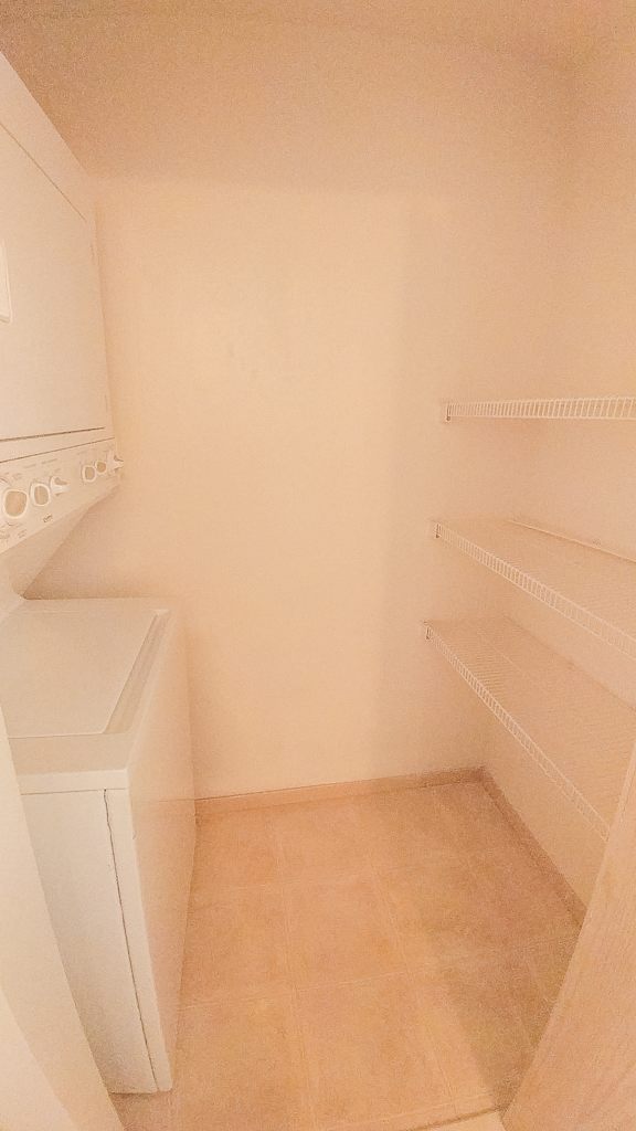 A small laundry room with a washer and dryer.