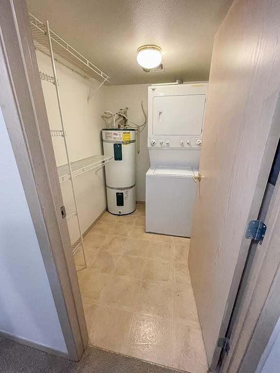 A small white fridge and a white oven in a small kitchen.