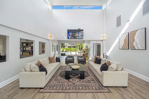 A living room with a rug and two couches.