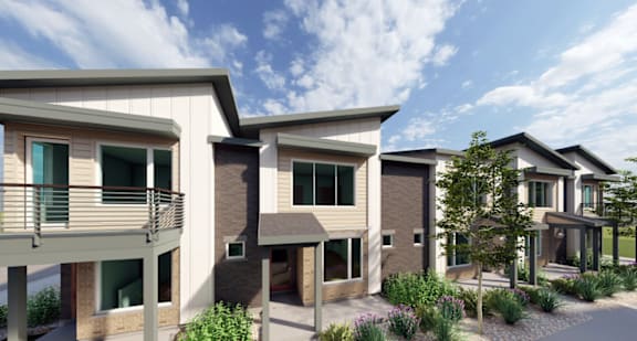 A row of modern houses with balconies and windows.