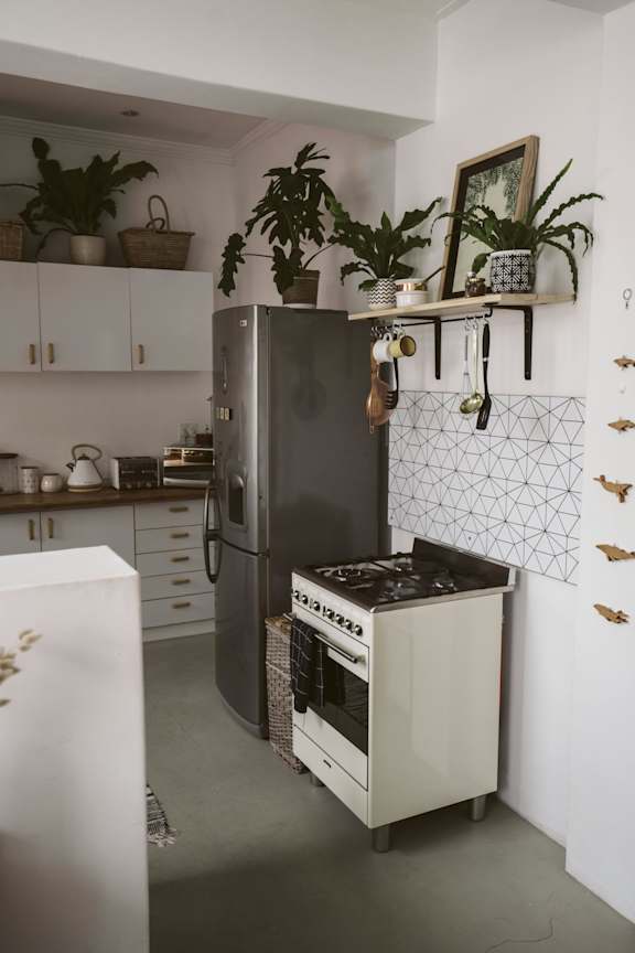 A modern kitchen with a black fridge and a white dishwasher.