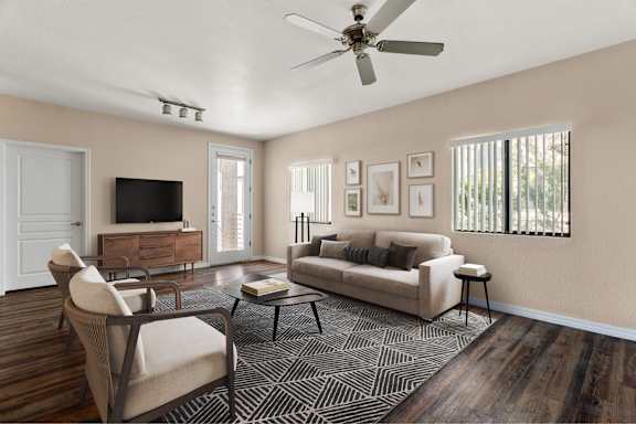 A living room with a couch, chair, and television.