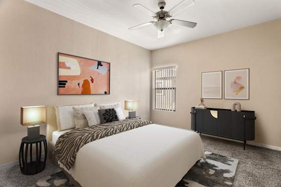 A bedroom with a bed, nightstand, and artwork on the wall.
