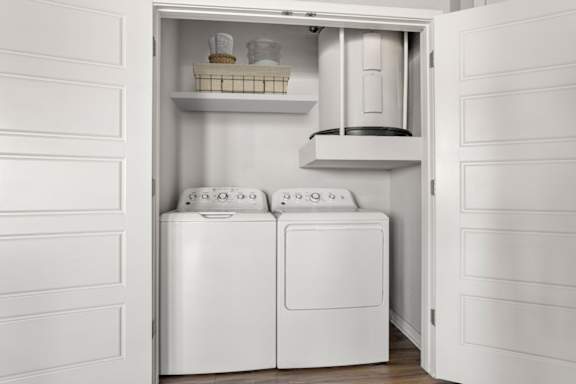 A white laundry room with a washer and dryer in it.