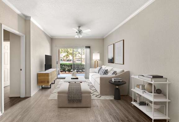 A living room with a couch, a coffee table, and a television.