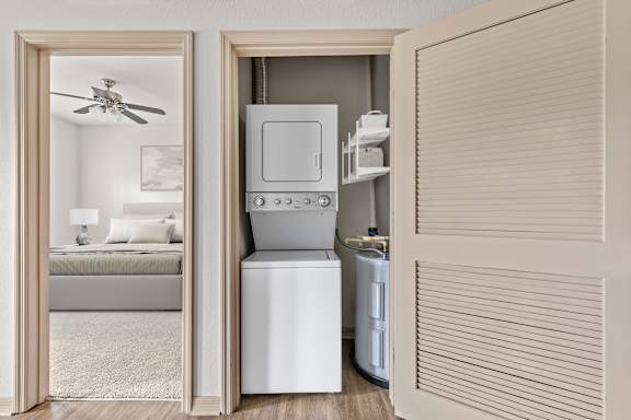 A modern kitchen with a white fridge and a white washing machine.