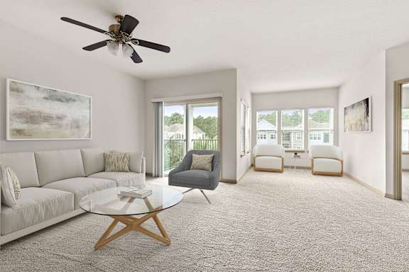 A living room with a grey couch, a glass coffee table, and a ceiling fan.