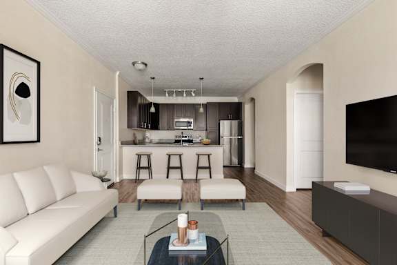 A modern living room with a white sofa, a glass coffee table, and a flat-screen TV.
