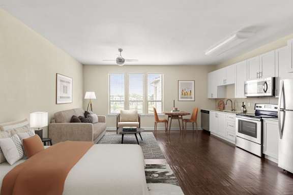 A well-lit, spacious living room with a kitchen area in the background.