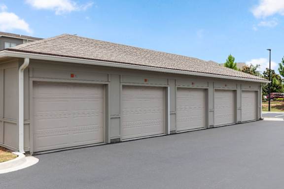 A row of closed garage doors in front of a building.