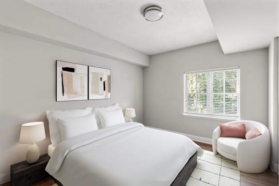 A bedroom with a bed, a chair, and a painting on the wall.