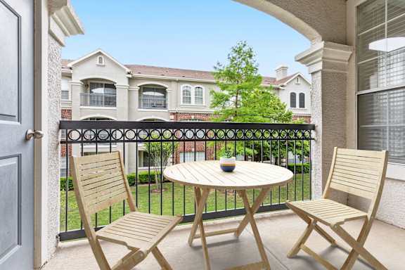 A patio with a table and two chairs is shown.