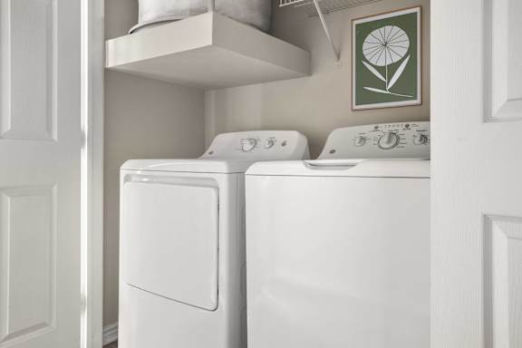 A white dryer and washer in a laundry room.