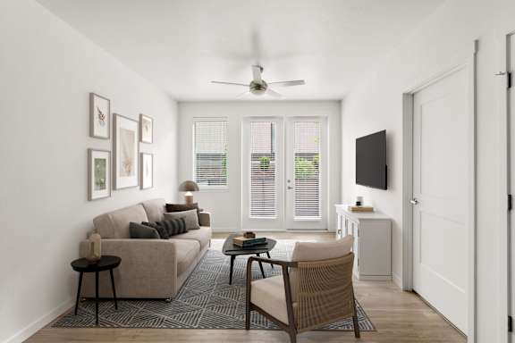 A living room with a couch, chair, and television.