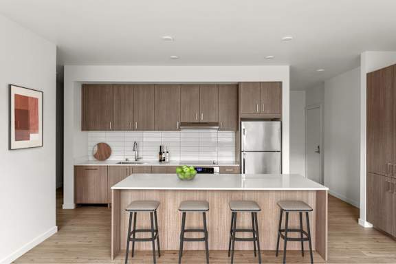 A modern kitchen with a white island and wooden cabinets.