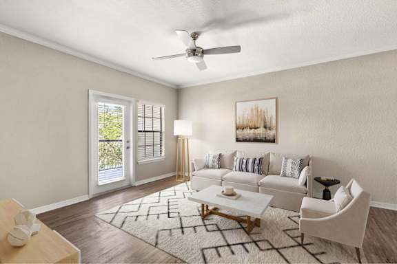 A living room with a white couch and a rug.