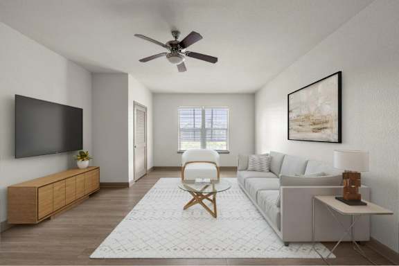 A living room with a grey sofa, a wooden chair, a television, and a painting on the wall.