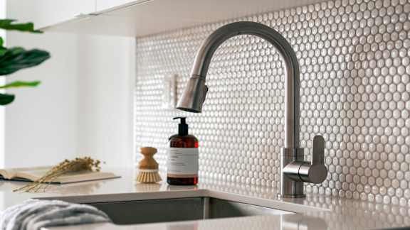 Modern kitchen sink with penny tile backsplash at 929 Richmond Apartments, Ottawa, ON K2B 6R1