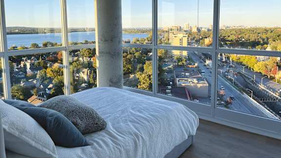 Bedroom with floor to ceiling windows at 929 Richmond Apartments, Ottawa, ON