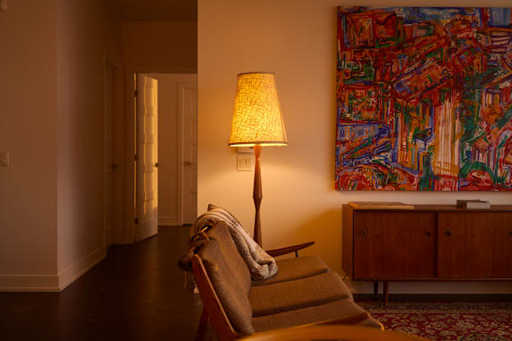 A living room with a couch, a chair, a table, and a rug.