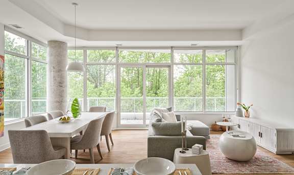 A living room with a couch, a chair, a table, and a rug.