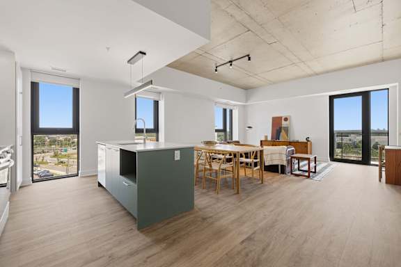 A kitchen with a table and chairs in the middle of the room.