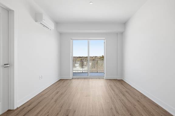 A room with a sliding glass door leading to a balcony. at Château golf, Gatineau, QC J9H 0M9