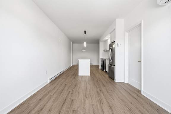 A white box is on a wooden floor in a white room. at Château golf, Gatineau