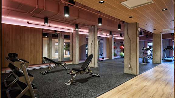 A gym with a wooden floor and a row of chairs. at Château golf, Gatineau