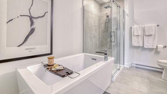 A white bathroom with a marble picture on the wall.