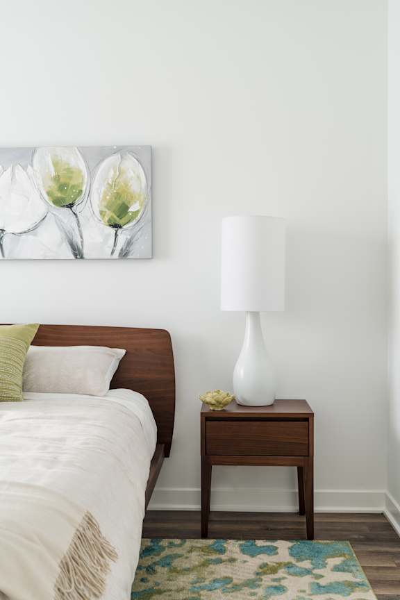 A living room with a white couch and a large window.
