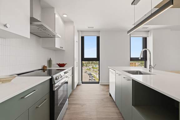 A modern kitchen with a view of the street outside.