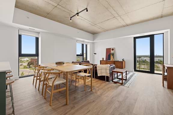 A dining room with a table and chairs.