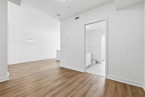 A room with wooden floors and white walls. at Château golf, Gatineau, QC J9H 0M9