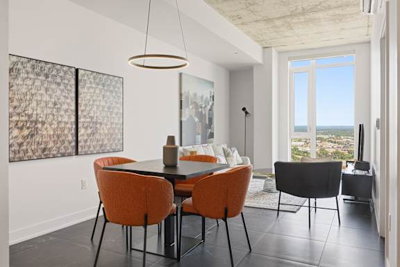 A modern dining room with a table set for four.