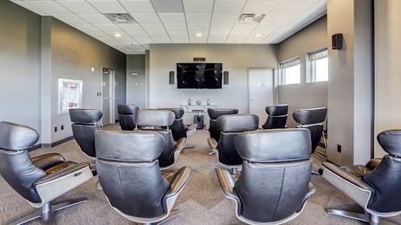A conference room with a large table and chairs.