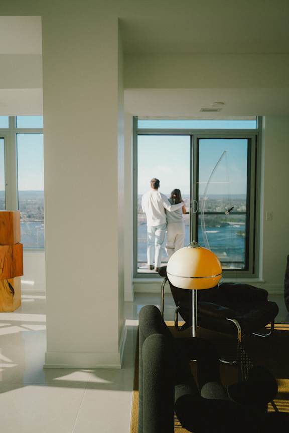 A living room with a white couch and a large window.