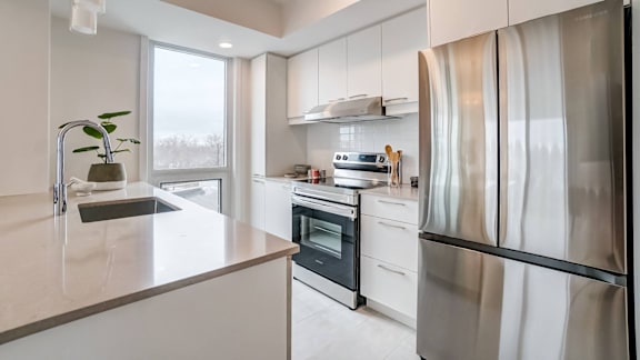 Modern kitchen with stainless steel appliances at Baseline Apartments, Ottawa, K2H 0C9