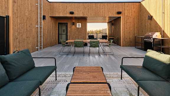 A wooden deck with a table and chairs.