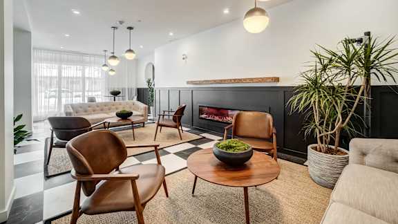 A modern living room with a fireplace and a variety of seating options.