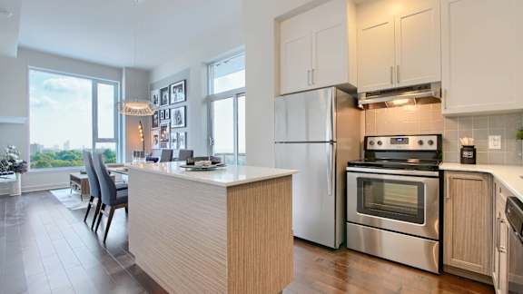 A kitchen with a stove, oven, and refrigerator.