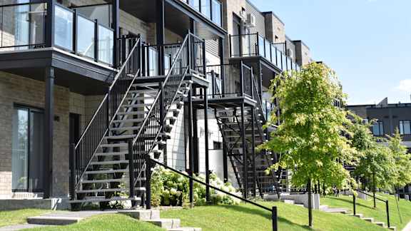 A modern building with a black metal staircase.
