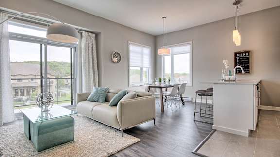 A living room with a white sofa and a glass coffee table.