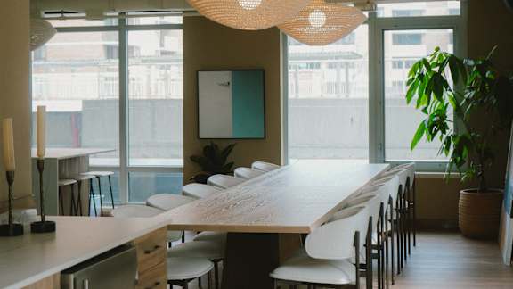 A long table with chairs and a plant in a pot at The Dale Apartments , Ottawa, ON