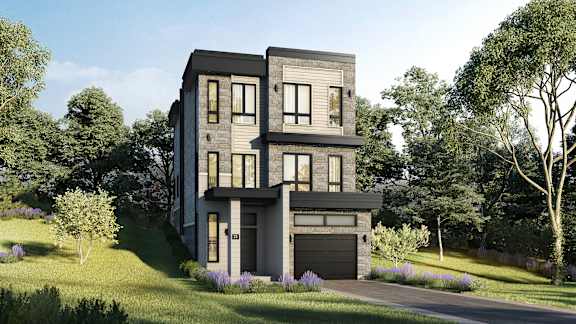A modern house with a grey exterior and a black garage door.