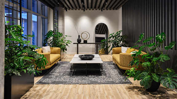 A living room with a yellow sofa and a coffee table. at Le ColumbiaApartments , Quebec, J8Y 0A8