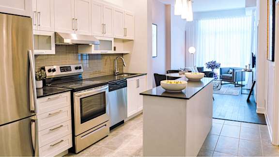 Modern kitchen with stainless steel appliances and island at Petries Landing II Apartments, Ontario